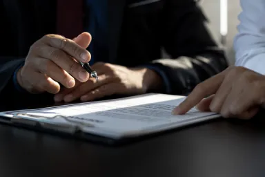 Close up of 2 people working on a document