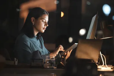 Women working on an ipad in a dark room