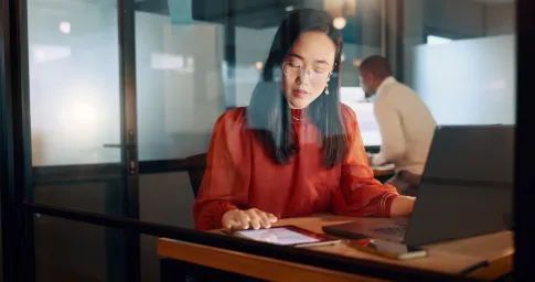 Woman in red top working at a desk