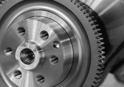 Close up for a round steel cog with six screw holes