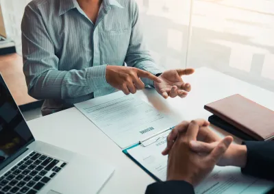 Two people working at a desk 