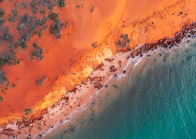 Landscape with orange earth and dark blue water