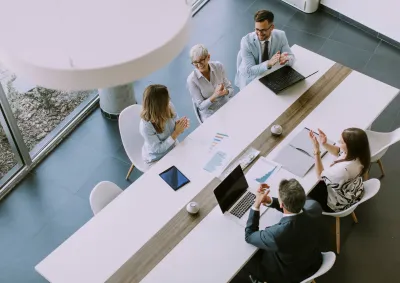 Overhead shot of 5 colleagues working at a table