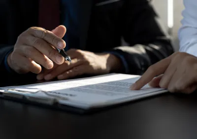 Close up of 2 people working on a document